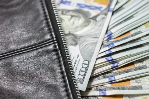 Dollar notes in a wallet, hundred-dollar bills are in a bag, Stock Photos