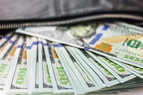 Dollar notes in a wallet, hundred-dollar bills are in a bag, Stock Photos