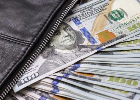 Dollar notes in a wallet, hundred-dollar bills are in a bag, Stock Photos