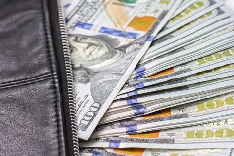 Dollar notes in a wallet, hundred-dollar bills are in a bag, Stock Photos