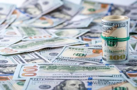 Dollar roll on the background of dollar bills Stock Photos
