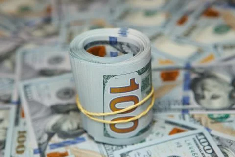 Dollar roll on background of many dollars Stock Photos