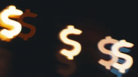 Dollar sign shaped bokeh of car lights at night. Stock Footage 80477772