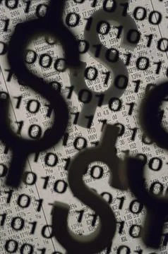 Dollar signs superimposed over binary code 写真素材
