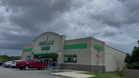 Dollar Tree retail store exterior building sign and parked cars storm clouds Stock-Footage 201382091
