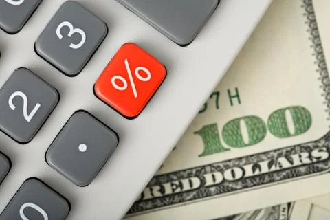 Dollars and calculator with percent red button Stock Photos
