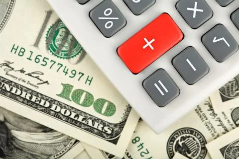 Dollars and calculator with plus red button Stock Photos