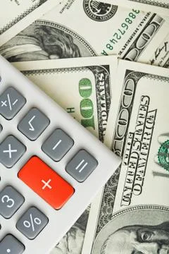 Dollars and calculator with plus red button Stock Photos