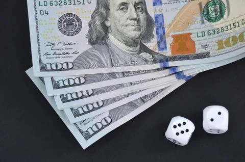 Dollars and cubes on a black table.	 Stock Photos