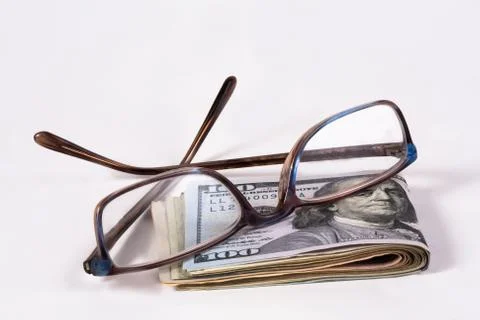 Dollars and glasses Stock Photos