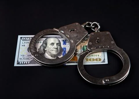 Dollars and Handcuffs Stock Photos