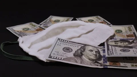Dollars and mask lay on the black background Stock Footage 127857845
