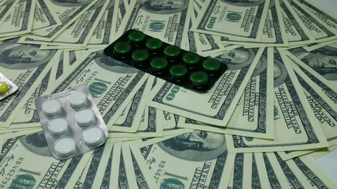 Dollars and medications on the table Stock Footage 88408535