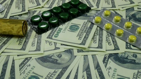 Dollars and medicines on the table in the office Stock Footage 88408559