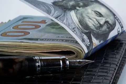Dollars and  pen, notebook Stock Photos