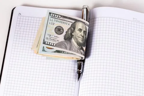 Dollars and pen, notebook Stock Photos