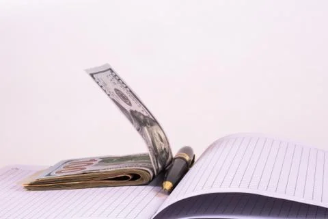 Dollars and pen, notebook Stock Photos