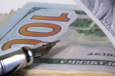 Dollars and  pen Stock Photos
