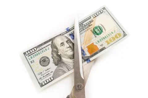 Dollars are cutting with scissors on a white background. Stock Photos