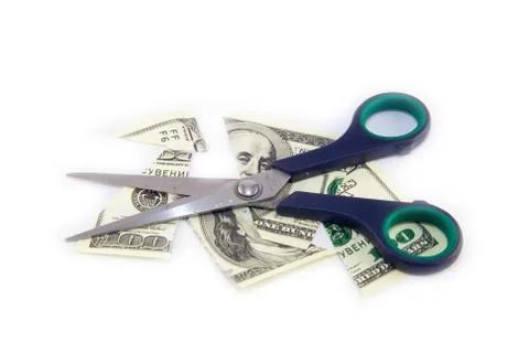 Dollars are cutting with scissors on a white background. Stock Photos