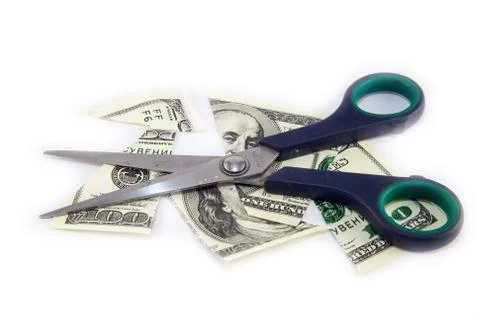 Dollars are cutting with scissors on a white background. Stock Photos