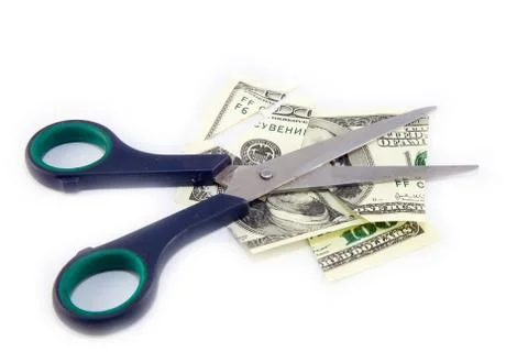 Dollars are cutting with scissors on a white background. Stock Photos