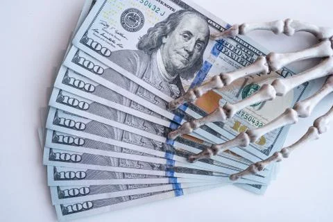 Dollars bills in skeleton hands isolated on white table, money Illustrazione stock