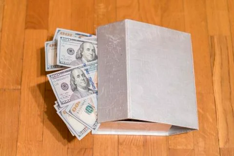 Dollars in a box. Small treasure box full with money, US 100 dollar bills. Stock Photos