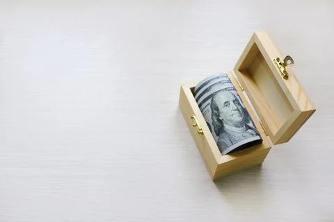Dollars bundle in a wooden box Stock Photos