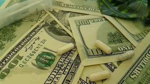 Dollars capsules hand gloves slow-motion shooting Stock Footage 90042414
