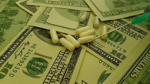 Dollars capsules syringe hand gloved slow-motion Stock Footage 90042076