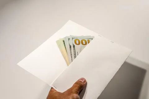 Dollars in a conwind on white background, a lot of money in an envelope. Stock Photos