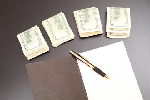 Dollars with a copybook Stock Photos