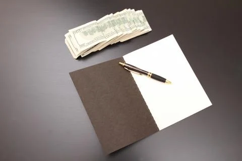 Dollars with a copybook Stock Photos
