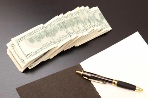 Dollars with a copybook Stock Photos