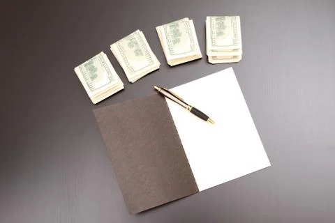 Dollars with a copybook. Stock Photos
