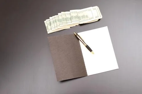 Dollars with a copybook Stock Photos