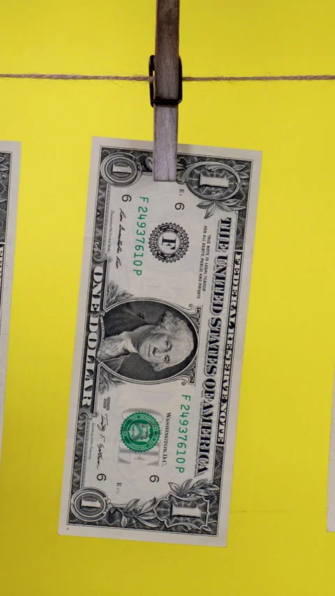 Dollars dry on a clothespin rope Stock Footage 314837875