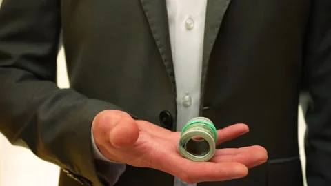 Dollars fall from above. Closeup view man's hand catches wad money. Slow motion Video stock 234074270