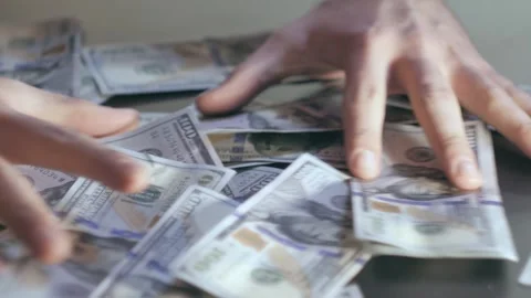 Dollars fall onto the table 스톡 동영상 284444407