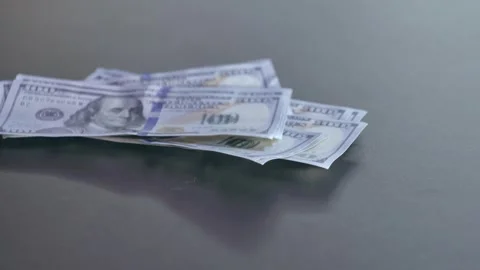 Dollars fall onto the table Video stock 284444767