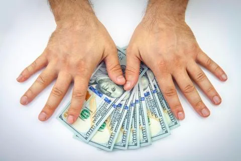Dollars in hand Stock Photos
