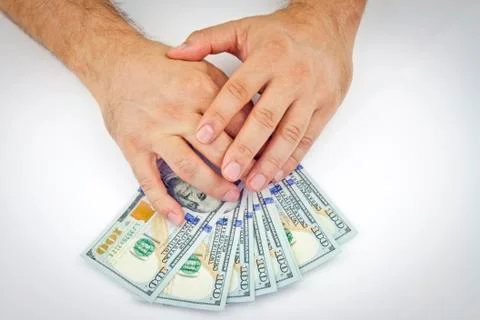 Dollars in hand Stock Photos