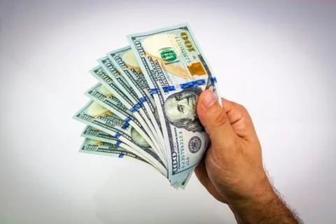 Dollars in hand Stock Photos