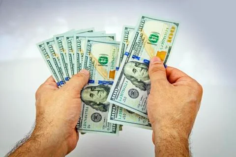 Dollars in hand Stock Photos