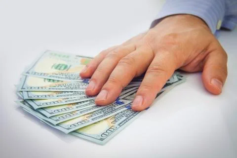 Dollars in hand Stock Photos
