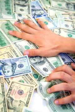 Dollars in hand Stock Photos