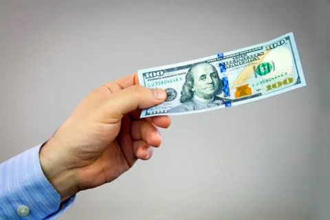 Dollars in hand Stock Photos