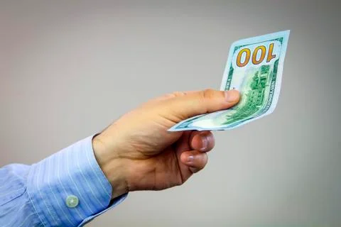 Dollars in hand Stock Photos