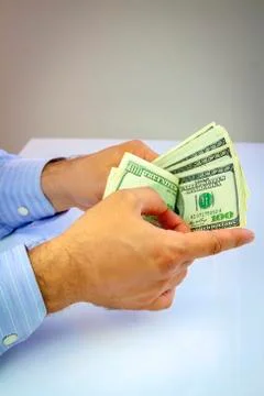 Dollars in hand Stock Photos